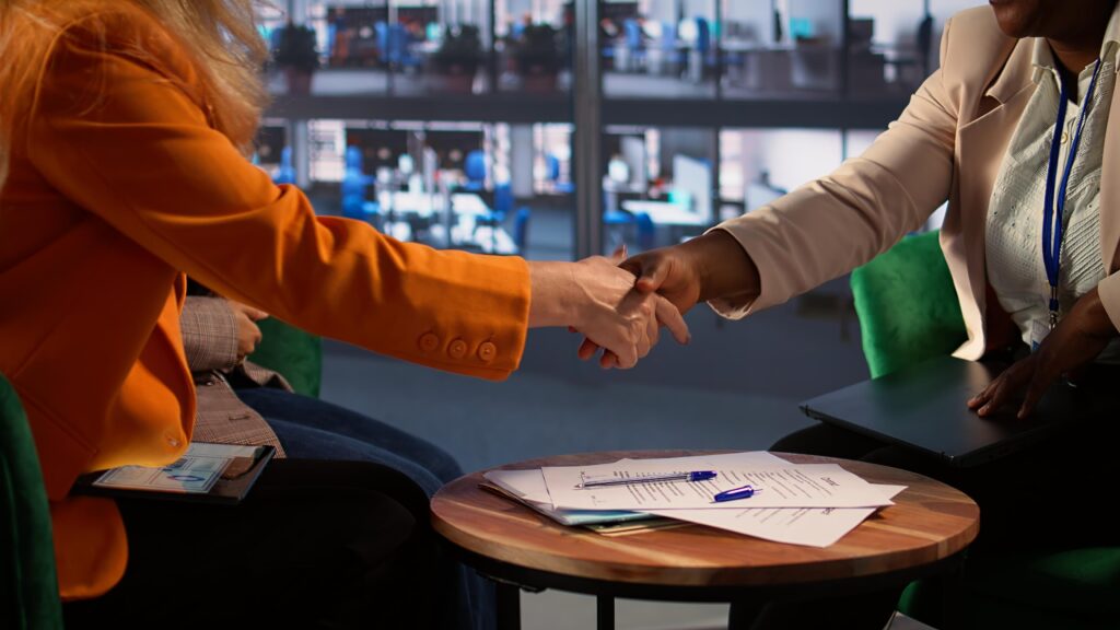 Two women shaking hands